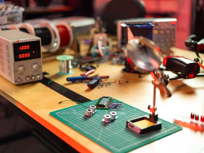 Electronics workspace with microcontroller and soldering tools